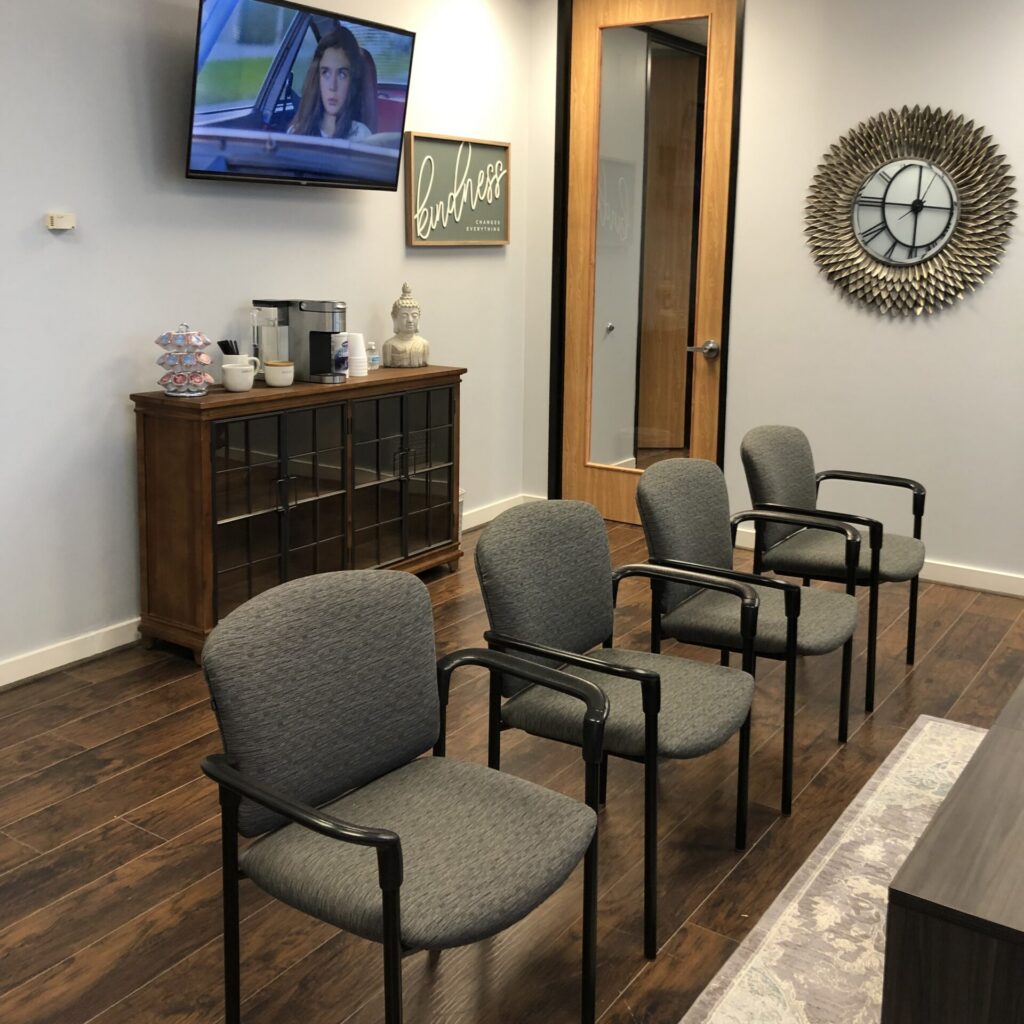 Waiting room of Option1 with tv and beverage station
